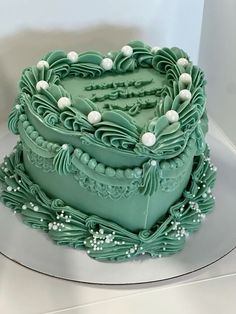 a green cake sitting on top of a white plate