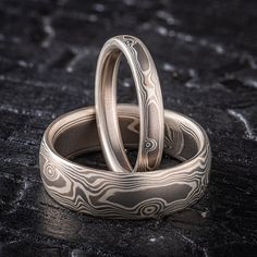 "* Price may vary depending on ring size, please inquire with us directly with your needed size for accurate pricing! This superb  Mokume Gane ring set is shown in the Twist pattern and Smoke Palette, with a low dome profile, and a satin finish. The Smoke palette features a three metal combination of 14k White Gold, Palladium, and Sterling Silver.  Price listed is for the set pictured above in a 3mm and a 7mm  Please inquire for individual rings Mokume Gane Band 1 Pattern: Woodgrain Palette: Smoke Finish: Satin Profile: Low Dome  Width Shown: 3mm Size Shown: 7 Mokume Gane Band 2 Pattern: Woodgrain Palette: Smoke Finish: Etched Profile: Low Dome  Width Shown: 7mm Size Shown: 10.5 Price does NOT include stones or setting fees. We care about customer service and would like to hear from you! P Mokume Gane Ring Wedding, Ring Wedding Set, Mokume Gane Ring, Twist Pattern, Mokume Gane, Wedding Set, Ring Wedding, Cute Jewelry, Satin Finish