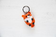 a crocheted keychain with an orange and white tiger on it