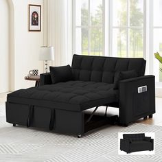 a black futon sofa bed in a living room