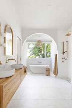 a large bathroom with two sinks and a bathtub