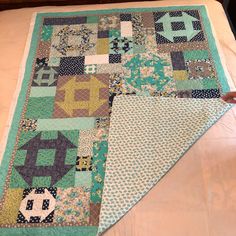 a quilted table runner on top of a bed