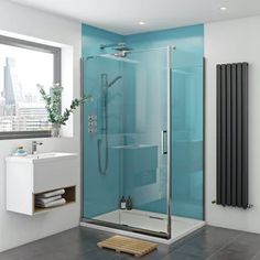 a bathroom with a glass shower stall, sink and radiator