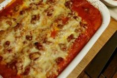 a casserole dish filled with meat and cheese