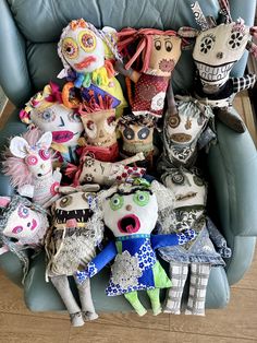 a group of stuffed animals sitting on top of a blue chair