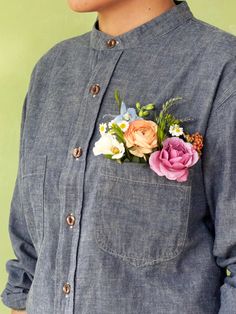 a person wearing a blue shirt with flowers in the pocket