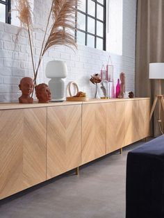 a large wooden cabinet with vases and other decorative items on it's sides