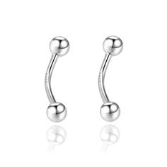 two silver balls are attached to the back of a pair of ear piercings,