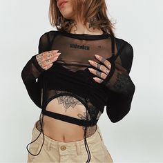 Crop Top Sheer Mesh Material High Neckline Long Sleeves Lined Bust With Buckles Attached Cropped Silhouette Buckle 95% Polyester, 5% Spandex Take Care Of Me Cold Hand Wash Size & Fit Fits True To Size Alexia Is Wearing Size S Alexia’s Stats: Height 5'8", Bust: 32, Waist: 24, Hips: 34, Size 2 Black Y2k Mesh Top For Summer, Y2k Black Mesh Top For Summer, Y2k Black Mesh Top For Night Out, Y2k Style Black Mesh Top For Summer, Black Stretch Mesh Top Y2k Style, Black Stretch Mesh Top In Y2k Style, Black Y2k Stretch Mesh Top, Trendy Black Sheer Crop Top, Fitted Black Y2k Mesh Top