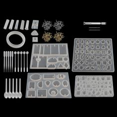 an assortment of plastic parts and tools on a black background