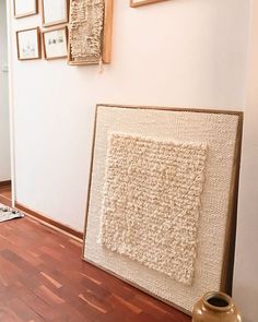 a room with pictures on the wall and a rug