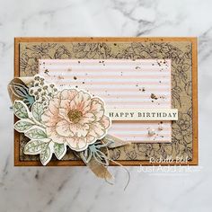 a close up of a birthday card with flowers on the front and back of it