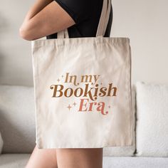 This Book Tote Bag is a stylish upgrade to reusable tote bags. This Bookish canvas tote bag make a great reusable tote for yourself or as a gift tote for book lovers. ⚡ USA Fast Delivery. We Deliver Within A Week. ⚡ Our Tote Bags are made with 100% cotton sheeting. Add their reinforced handle stitching to the mix, and you got a reliable bag rich in both practicality and durability. These durable totes are crafted with a last technological DTG printer for a vibrant flawless finish. Tote bags will Bookstore Cafe, Library Bag, Page Borders Design, Book Tote Bag, Gift Totes, Origami Crafts Diy, Crochet Basket Pattern, Cute Tote Bags, Gifts For Bookworms