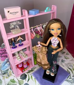 a doll is standing in front of a pink shelf