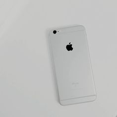 an iphone is sitting on top of a white surface with its back facing the camera