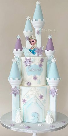 a frozen princess castle cake with frosting and purple icing on the top tier