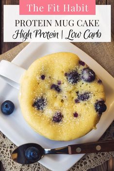 a blueberry cake on a white plate with spoons