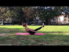 a woman is doing yoga in the park