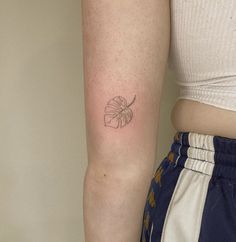 a woman with a small tattoo on her arm