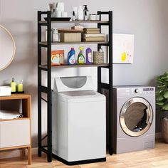 a washer sitting next to a dryer in a room with shelves on the wall