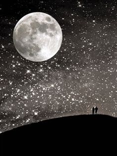 two people standing on top of a hill in front of a full moon and stars