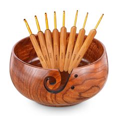 a wooden bowl filled with lots of yellow toothbrushes