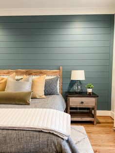 a bedroom with blue walls and wooden furniture