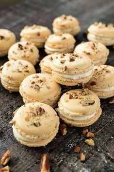 there are many small cookies with nuts on the table next to each other and one is half eaten