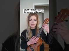 a woman is holding an ukulele in front of her face with the caption'your bellybutton used to be your old mouth '