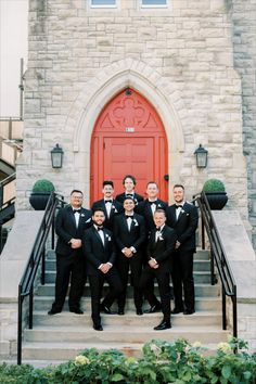 a group of men in tuxedos are posing for a photo on the steps