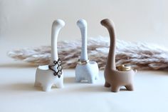 three small ceramic animals sitting next to each other