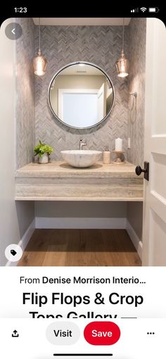 a bathroom sink sitting under a mirror next to a light on top of a wooden floor