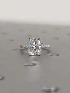 an engagement ring with a princess cut diamond