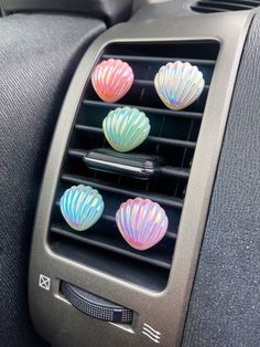 an air vent in the back of a car with colorful shells on it's dashboard