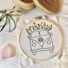 a cross stitch pattern with a vw bus and flowers in the front on a white background