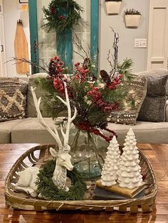 a living room filled with furniture and christmas decorations on top of a wooden coffee table