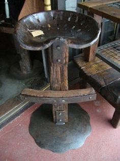 an old wooden chair sitting on top of a floor next to a table and chairs