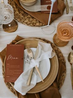 a place setting with napkins, silverware and utensils on a table