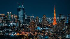 the city skyline is lit up at night, with bright lights shining on the skyscrapers