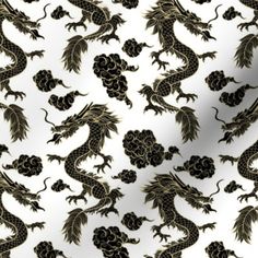 a black and gold dragon pattern on white fabric