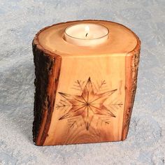 a wooden candle holder with a star design on it