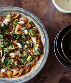 a pizza sitting on top of a pan covered in cheese and toppings next to a black plate