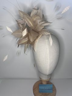 Natural Feather Puff fascinator is a stunning accessory made from high-quality goose nagorie and coque feathers. The feathers are expertly arranged in a circular shape to create a voluminous and fluffy look, perfect for adding a touch of glamour to any outfit. The feather puff is attached to a sinamay base, which adds structure and stability to the design. The base is then securely attached to a color-coordinated headband, making it easy to wear and comfortable to keep in place. 🖤This head piece looks simply stunning and is perfect for weddings, special occasions or a day at the races.  🖤All head pieces are finished with matching headband wrapped in co-ordinating silk ribbon or secure millinery elastic which is comfortable and easy hidden. 🖤Shipped in a sturdy (keepsake) box and packed Beige Fascinator For Parties, Fitted Beige Headpiece For Evening, Beige Party Fascinator, Elegant Beige Headpiece For Ceremonies, Fitted Beige Evening Headpiece, Fitted Feather Hair Accessories For Wedding, Beige Hair Accessories For Wedding, Cream Feathered Headpiece For Royal Ascot, Beige Fascinator For Ceremonies