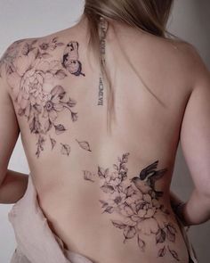 the back of a woman's body with flowers on it