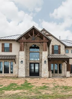 a large house with stone and wood accents