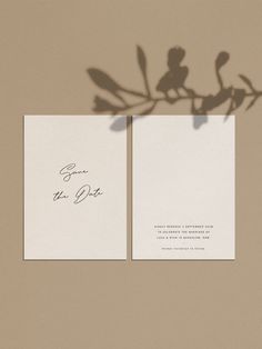 two wedding cards with the shadow of a plant on them