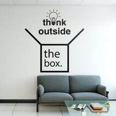 the think outside the box wall decal is in an office space with a couch and coffee table