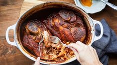 a person is spooning some food out of a pot