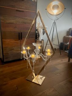 a candle holder with candles in it on a wooden floor