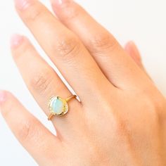 Just gaze into the shimmering opal center of this asymmetric bezel ring and drink in its tranquil beauty. Inspired by shimmering pools found in the desert, this ring features a gemstone cabochon in a golden bezel surrounded by an organic, scattered halo of diamonds. Delicate milgrain beading completes the design with a gentle touch of texture. Made in the U.S.A. 14 karat gold with 8 m x 6 mm opal center and nine round white diamonds totaling 0.045 carat. Bezel Ring, Gentle Touch, In The Desert, Opal Ring, White Diamonds, Opal Rings, The Desert, 8 M, Diamond White